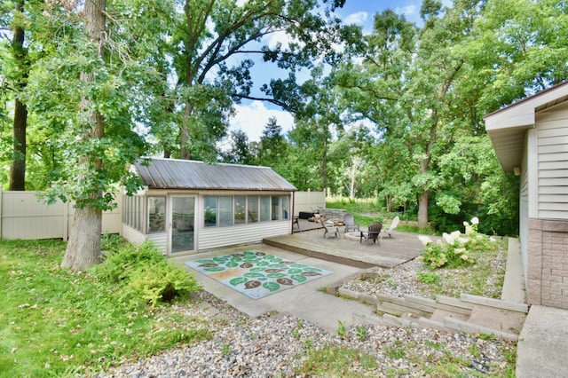 exterior space featuring a sunroom and a deck