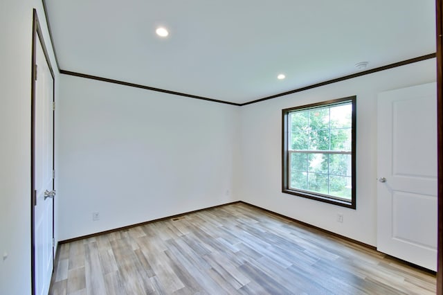 unfurnished bedroom featuring light hardwood / wood-style flooring and ornamental molding