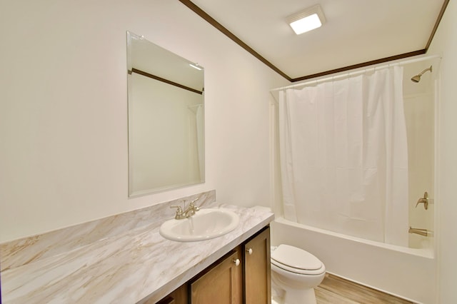 full bathroom featuring shower / bath combo, toilet, hardwood / wood-style flooring, vanity, and ornamental molding