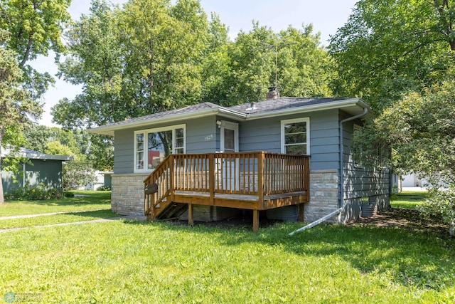 rear view of house featuring a yard and a deck