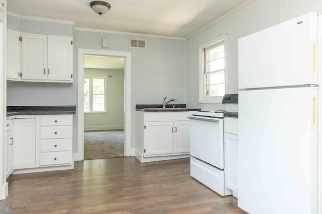 kitchen featuring white cabinetry, dark wood-type flooring, a healthy amount of sunlight, and white appliances