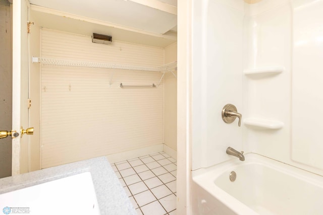 bathroom with tile patterned flooring and shower / bathtub combination