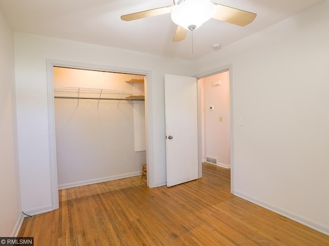 unfurnished bedroom with light wood-type flooring, a closet, and ceiling fan