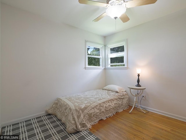 bedroom with hardwood / wood-style floors and ceiling fan