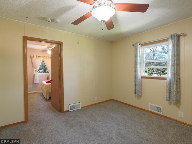 carpeted empty room featuring ceiling fan