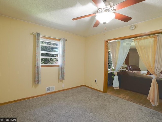 spare room featuring carpet and ceiling fan