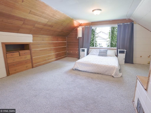 bedroom featuring light carpet, vaulted ceiling, wooden ceiling, and wood walls