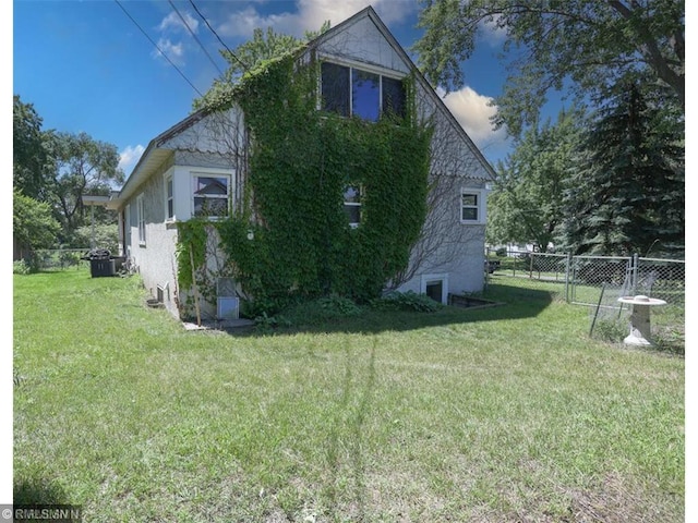 view of property exterior featuring a lawn