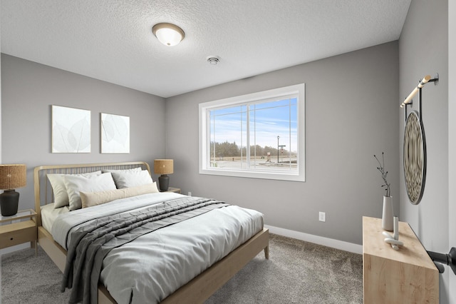 carpeted bedroom with a textured ceiling