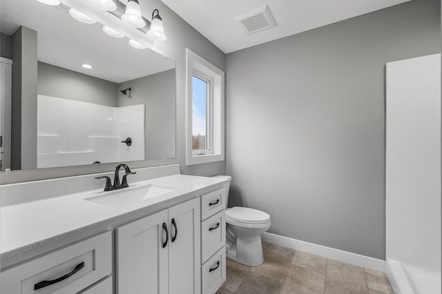 bathroom with a textured ceiling, vanity, toilet, and walk in shower