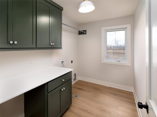 clothes washing area with cabinets, hookup for a washing machine, light wood-type flooring, and hookup for an electric dryer