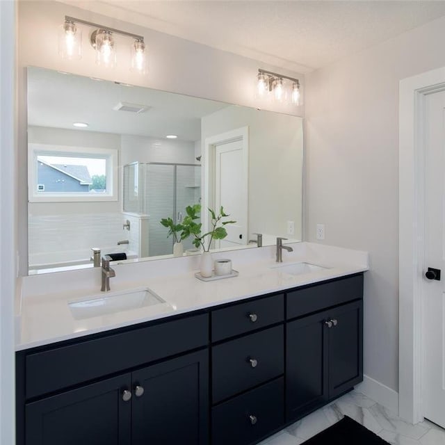 bathroom featuring vanity and a shower with shower door