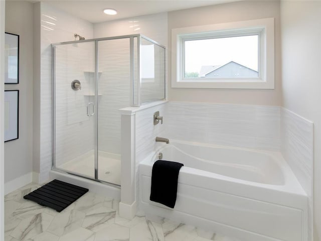 bathroom featuring shower with separate bathtub