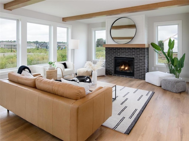 interior space with beam ceiling and a tile fireplace