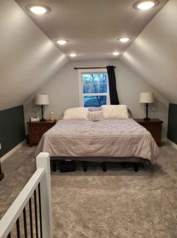 bedroom with carpet floors and lofted ceiling