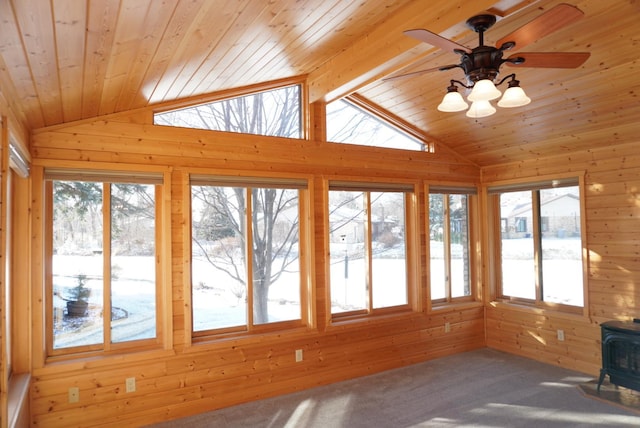 unfurnished sunroom featuring wooden ceiling, a wood stove, vaulted ceiling with beams, and ceiling fan