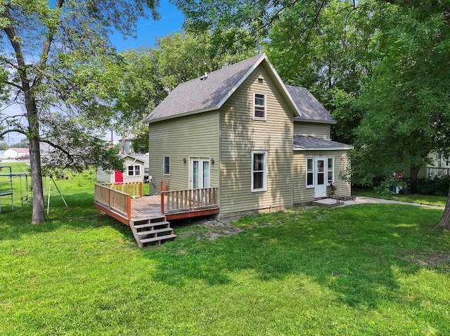 back of house with a lawn and a wooden deck