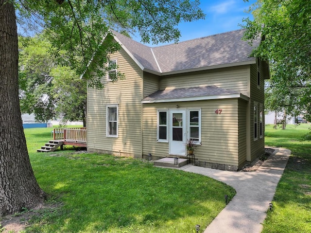 exterior space featuring a lawn and a wooden deck