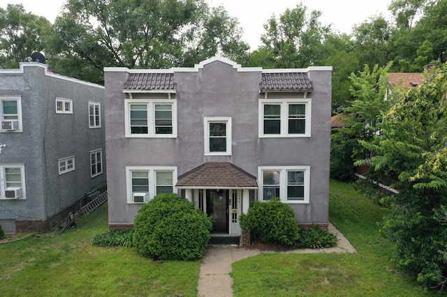 view of front of home featuring cooling unit and a front yard