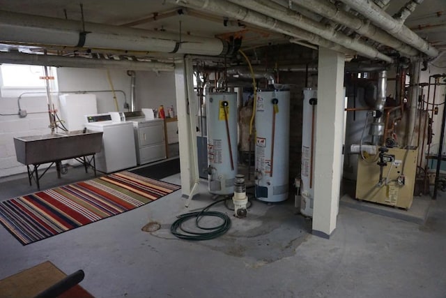 basement with sink, gas water heater, and independent washer and dryer