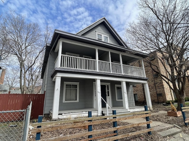 view of front facade with covered porch and a balcony