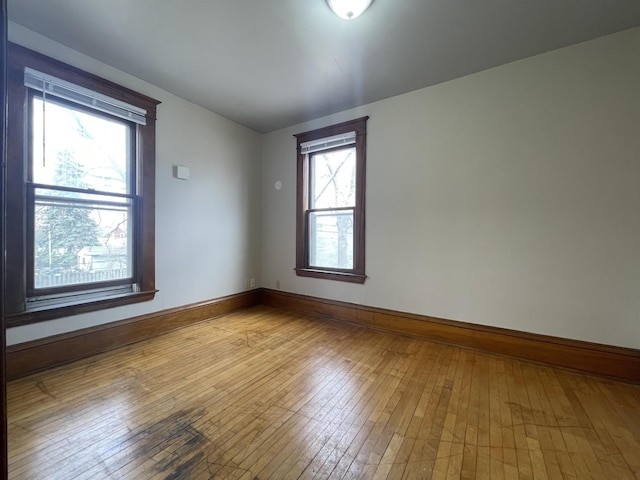 empty room with hardwood / wood-style flooring