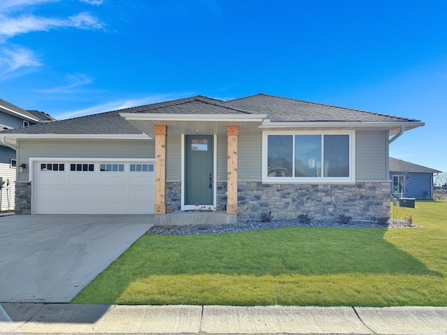 prairie-style house featuring a front lawn and a garage