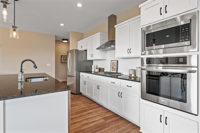 kitchen featuring white cabinets, sink, wall chimney exhaust hood, and stainless steel appliances