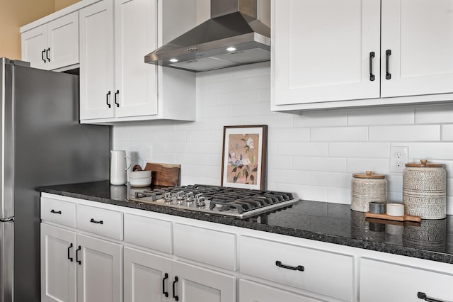 kitchen with backsplash, white cabinets, wall chimney exhaust hood, and stainless steel appliances