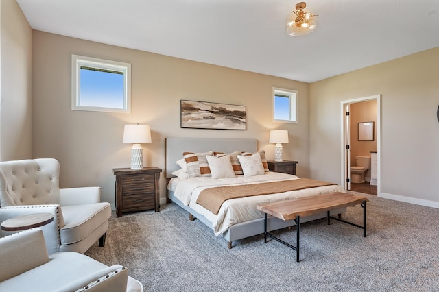 bedroom featuring ensuite bath and carpet