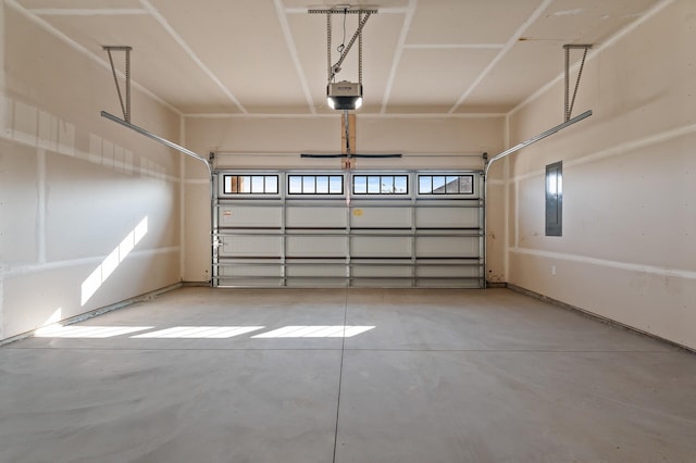 garage featuring electric panel and a garage door opener