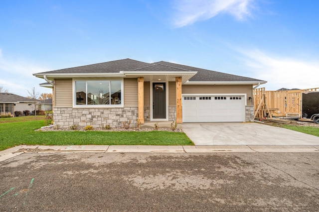 view of front of house with a garage and a front lawn