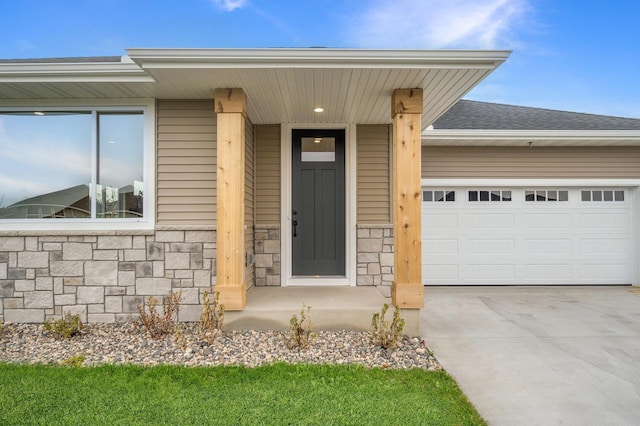1242 Willowbrook Cir, Delano, MN 55328 - doorway to property featuring stone siding, an attached garage, driveway, and a shingled roof