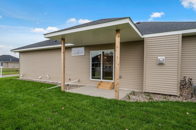 back of house with a patio area and a lawn