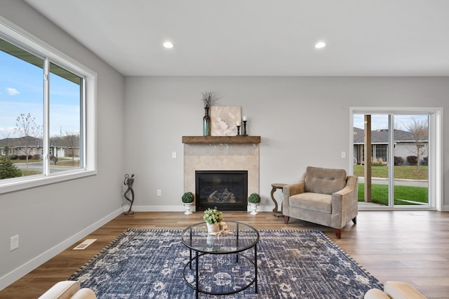 1242 Willowbrook Cir, Delano, MN 55328 - living room with plenty of natural light, wood finished floors, a tile fireplace, and recessed lighting