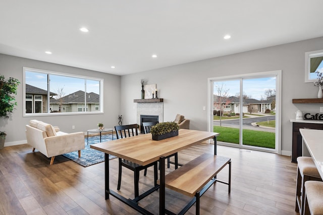 1242 Willowbrook Cir, Delano, MN 55328 - dining room with a glass covered fireplace, plenty of natural light, light wood-style flooring, and recessed lighting