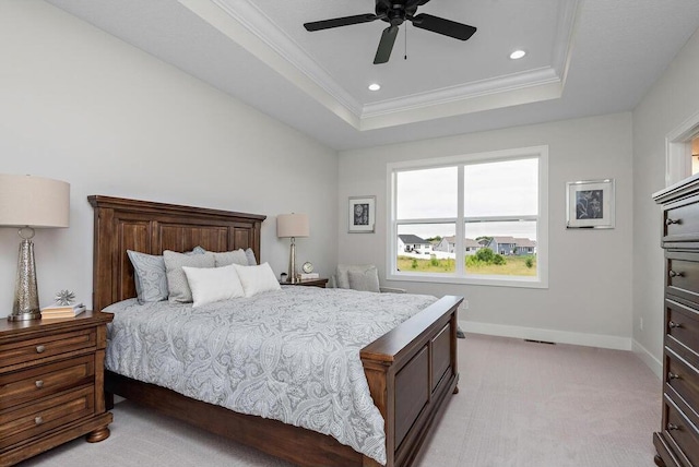 carpeted bedroom featuring ceiling fan, a raised ceiling, and ornamental molding