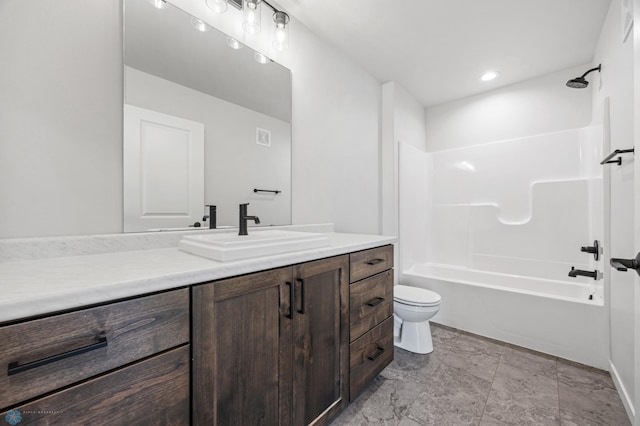 full bathroom featuring washtub / shower combination, vanity, and toilet