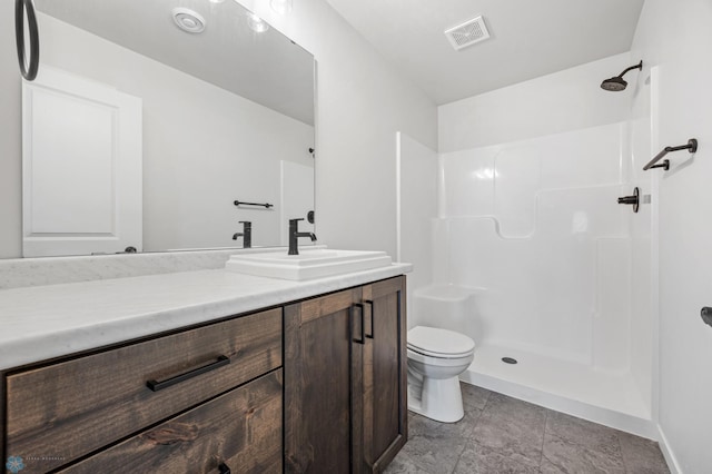 bathroom featuring vanity, toilet, and walk in shower