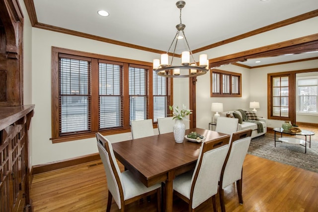 dining area with crown molding, light hardwood / wood-style flooring, and a healthy amount of sunlight