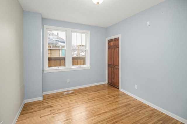 unfurnished room with light hardwood / wood-style flooring