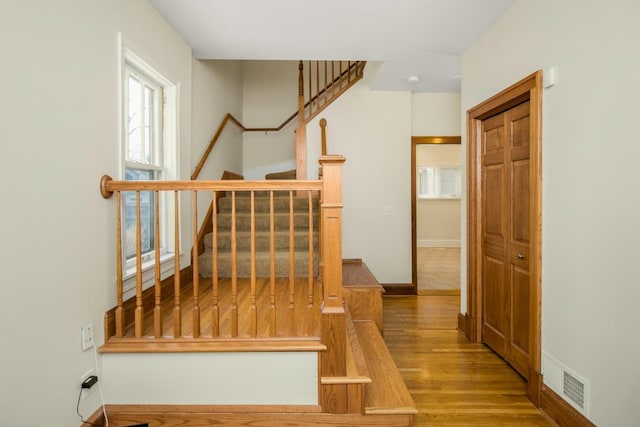 stairway with hardwood / wood-style flooring