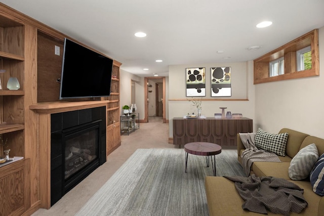 living room with a tiled fireplace and light carpet