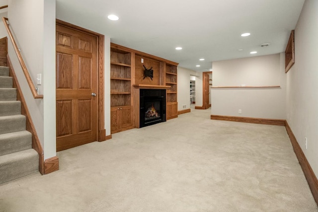 unfurnished living room with light colored carpet