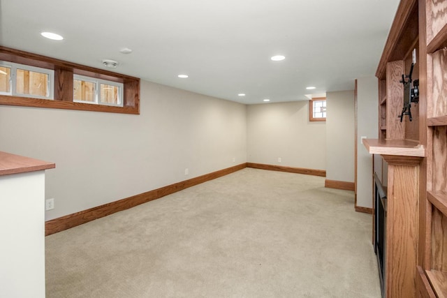 basement featuring light colored carpet