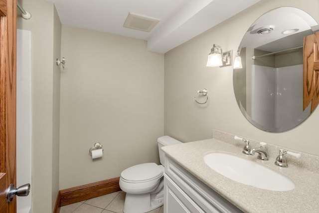 bathroom featuring a shower, vanity, tile patterned floors, and toilet