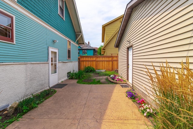 view of side of property with a patio area