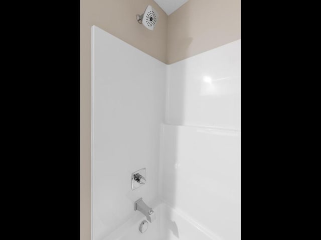 details featuring bathing tub / shower combination