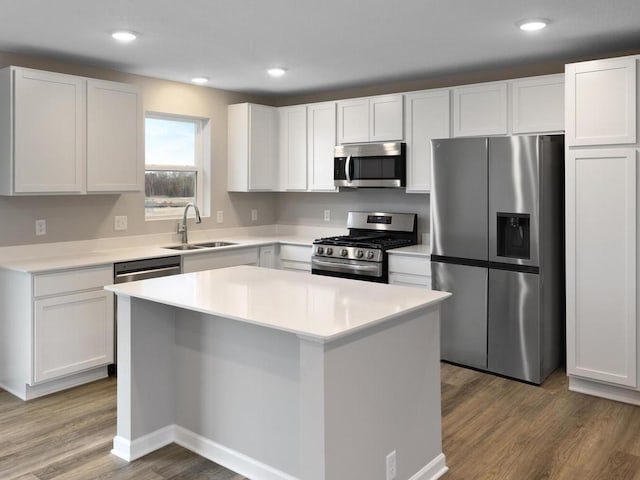 kitchen featuring white cabinetry, appliances with stainless steel finishes, dark hardwood / wood-style floors, and a kitchen island