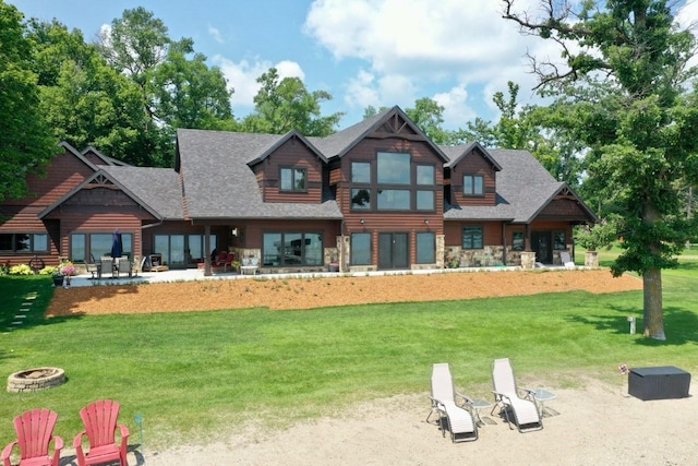 exterior space with a lawn, a patio, and an outdoor fire pit